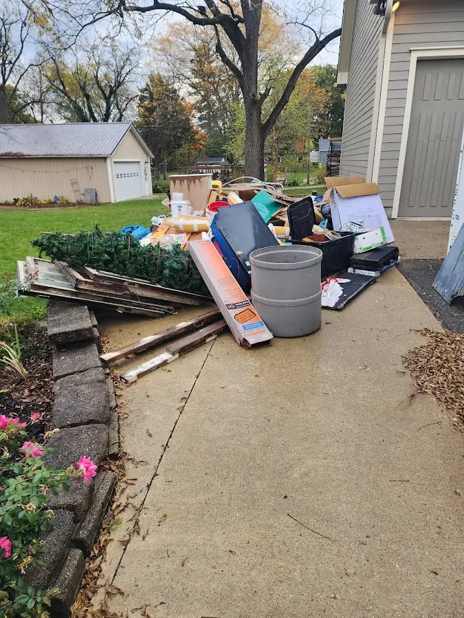 Dumpster being loaded with debris for Roofing Dumpster Rental in Schaghticoke
